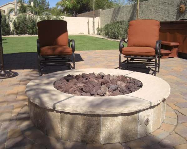 A nice firepit area with a hot tub in the background.